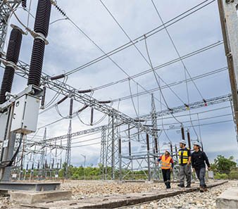 Three people are standing in front of a power plant. AI generated content