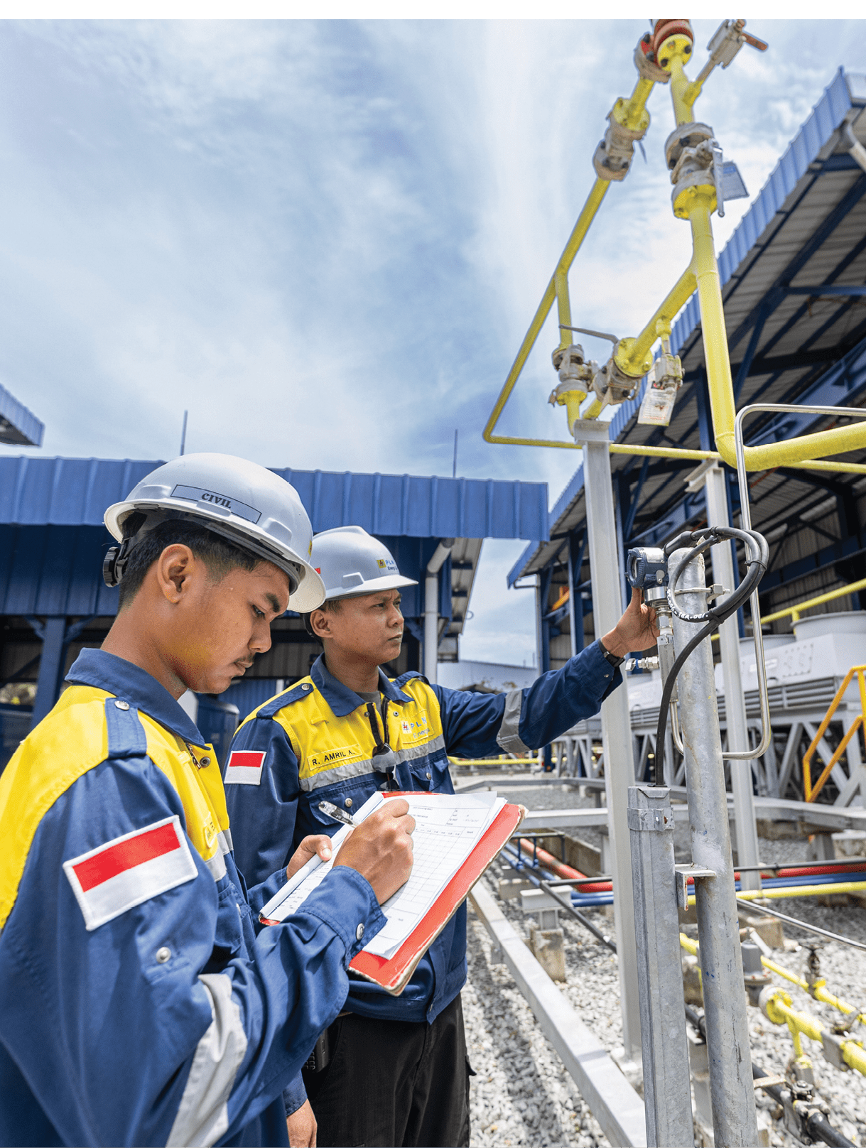 Two men in hard hats are standing next to a large yellow structure, looking at a piece of paper. AI generated content