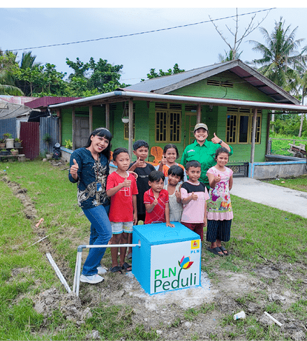 A group of people, including children, are standing in front of a house. They are posing for a picture in front of a blue box. AI generated content